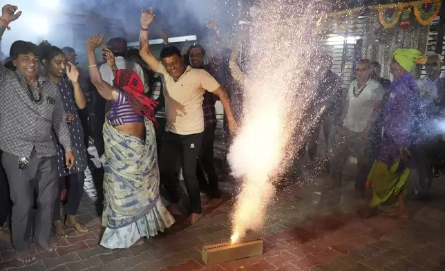 Villagers light fire crackers and dance as they celebrate the safe return of NASA astronaut Suni Williams from the International Space Station (ISS), at a temple in her ancestral village Jhulasan in Mehsana district of Gujarat state, India, Wednesday, March 19, 2025. (AP Photo/Ajit Solanki)