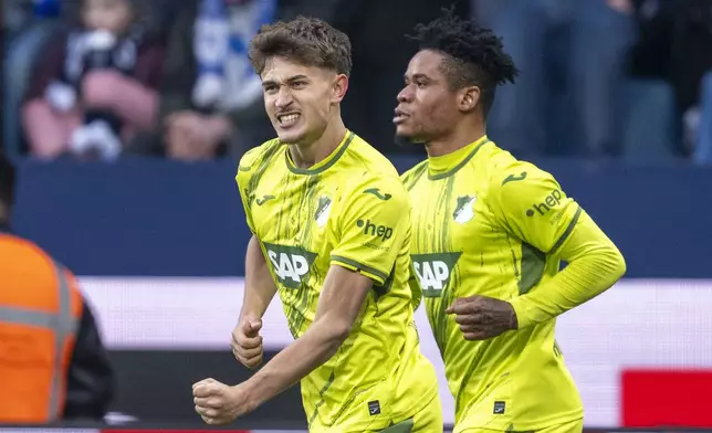 Hoffenheim's Tom Bischof, front, celebrates after scoring the opening goal during the German Bundesliga soccer match between VfL Bochum and TSG 1899 Hoffenheim in Bochum, Germany, Saturday, March 1, 2025. (David Inderlied/dpa via AP)