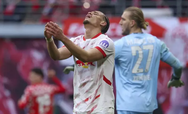 Leipzig's Xavi Simons, front, reacts during the German Bundesliga soccer match between RB Leipzig and FSV Mainz 05 in Leipzig, Germany, Saturday, March 1, 2025. (Jan Woitas/dpa via AP)