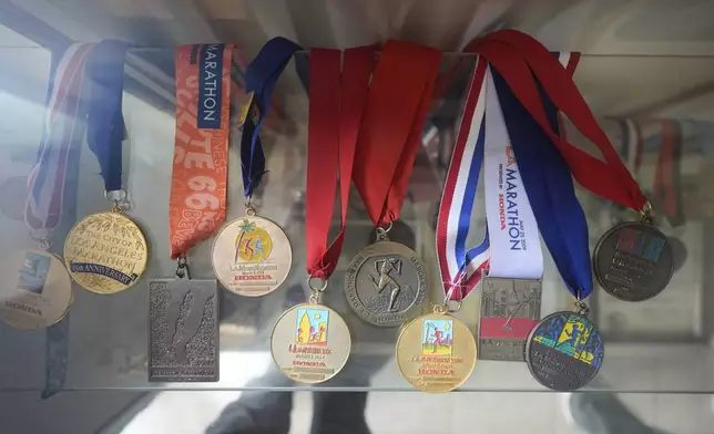 The Los Angeles Marathon medals from Rick Bingham, 87, are displayed at his home in Lake Elsinore, Calif., Tuesday, March 11, 2025. (AP Photo/Damian Dovarganes)