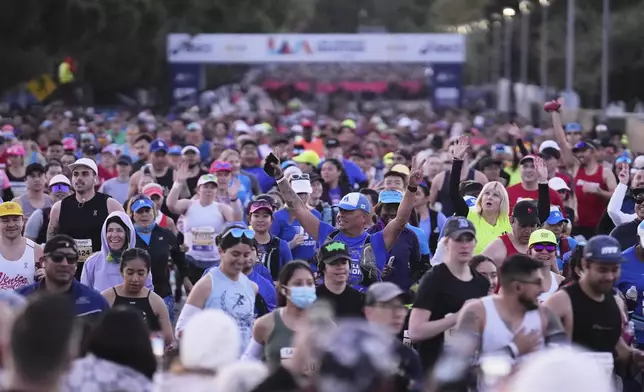 Participants prepare for the start of the Los Angeles Marathon Sunday, March 16, 2025, in Los Angeles. (AP Photo/Eric Thayer)