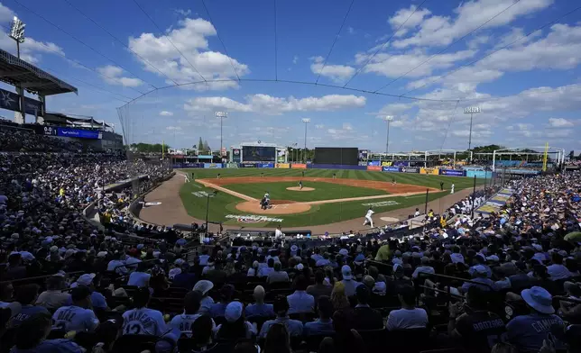 A sell out crowd watches during the second inning of a baseball game between the Tampa Bay Rays and the Colorado Rockies at Steinbrenner Field Friday, March 28, 2025, in Tampa, Fla. (AP Photo/Chris O'Meara)