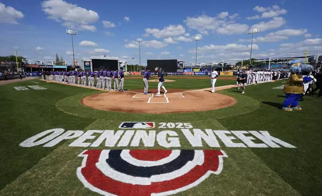 Colorado Rockies manager Bud Black and Tampa Bay Rays manager Kevin Cash shakes hands during player introductions before a baseball game Friday, March 28, 2025, in Tampa, Fla. (AP Photo/Chris O'Meara)