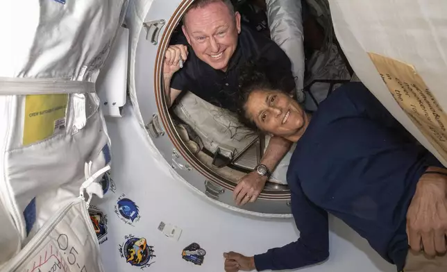 FILE - In this photo provided by NASA, Boeing Crew Flight Test astronauts Butch Wilmore, left, and Suni Williams pose for a portrait inside the vestibule between the forward port on the International Space Station's Harmony module and Boeing's Starliner spacecraft on June 13, 2024. (NASA via AP, File)
