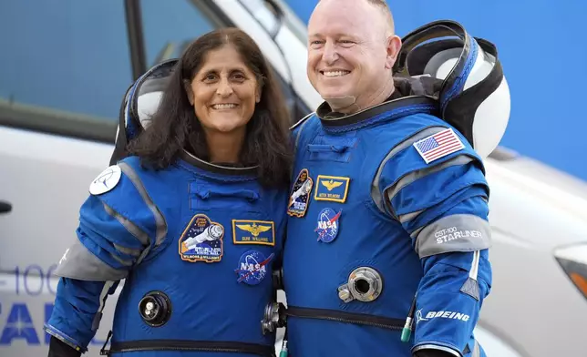 FILE - NASA astronauts Suni Williams, left, and Butch Wilmore stand together for a photo enroute to the launch pad at Space Launch Complex 41 Wednesday, June 5, 2024, in Cape Canaveral, Fla., for their liftoff on a Boeing Starliner capsule to the International Space Station. (AP Photo/Chris O'Meara, File)