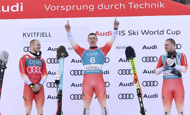 From left, second placed Switzerland's Marco Odermatt, the winner Switzerland's Franjo von Allmen and third placed Switzerland's Stefan Rogentin celebrate after an alpine ski, men's World Cup downhill, in Kvitfjell, Norway, Saturday, March 8, 2025. (AP Photo/Marco Trovati)