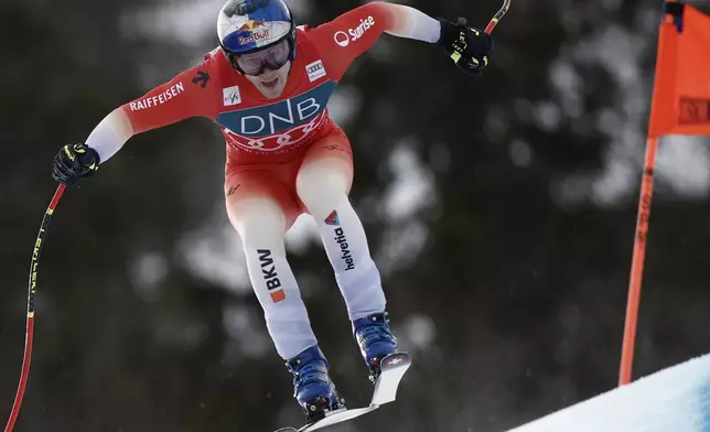 Switzerland's Marco Odermatt speeds down the course during an alpine ski, men's World Cup downhill, in Kvitfjell, Norway, Saturday, March 8, 2025. (AP Photo/Gabriele Facciotti)