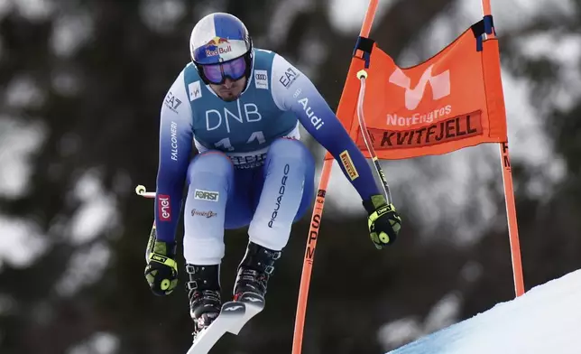 Italy's Dominik Paris speeds down the course during an alpine ski, men's World Cup downhill, in Kvitfjell, Norway, Saturday, March 8, 2025. (AP Photo/Gabriele Facciotti)