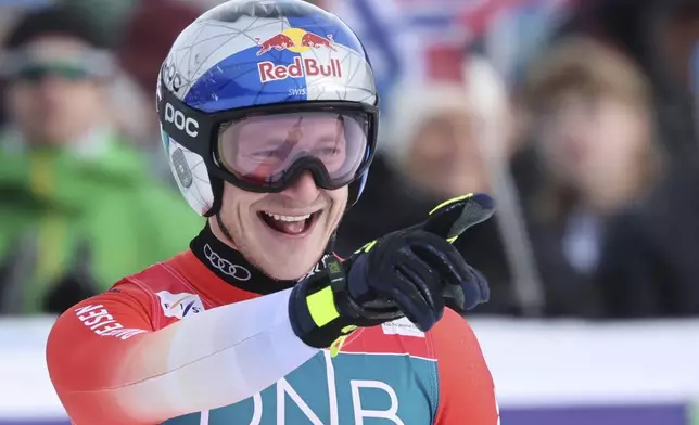 Switzerland's Marco Odermatt reacts after completing an alpine ski, men's World Cup downhill, in Kvitfjell, Norway, Saturday, March 8, 2025. (AP Photo/Marco Trovati)