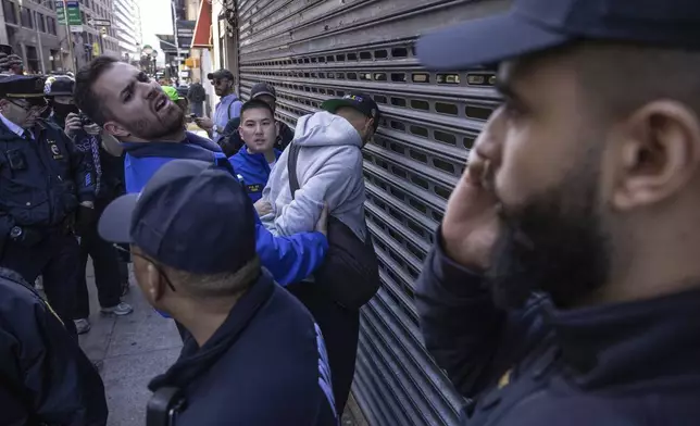 NYPD officers arrest a person during a demonstration in support of Palestinian activist Mahmoud Khalil, Tuesday, March 11, 2025, in New York. (AP Photo/Yuki Iwamura)