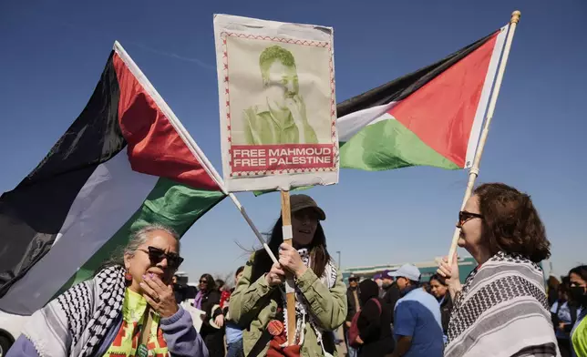 Protesters hold a sign for Mahmoud Khalil, a recently detained Palestinian activist, in Newark, N.J., Tuesday, March 11, 2025. The protest was held in front of Delaney Hall, the proposed site of an immigrant detention center. (AP Photo/Seth Wenig)