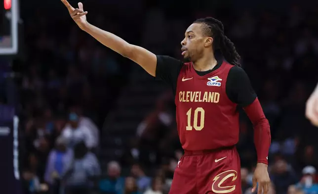 Cleveland Cavaliers guard Darius Garland gestures after scoring against the Charlotte Hornets during the first half of an NBA basketball game in Charlotte, N.C., Friday, March 7, 2025. (AP Photo/Nell Redmond)