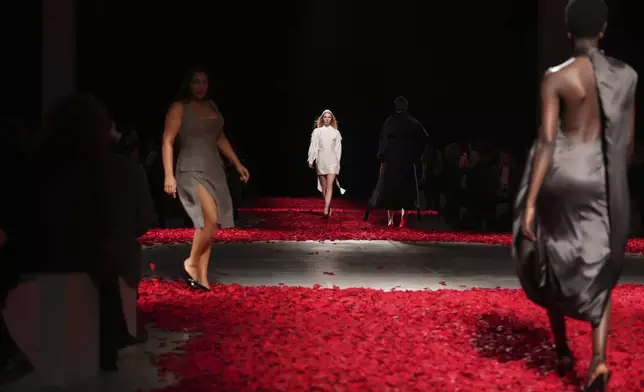 Models wear creations as part of the Ferragamo's Fall/Winter 2025-2026 collection presented in Milan, Italy, Saturday, March 1, 2025. (AP Photo/Antonio Calanni)