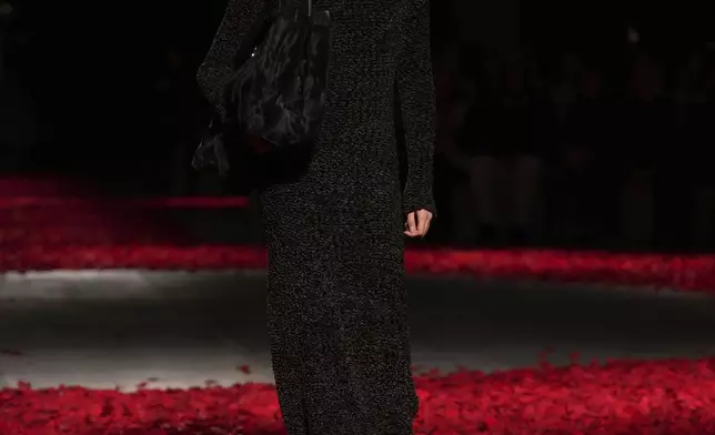 Models wear creations as part of the Ferragamo's Fall/Winter 2025-2026 collection presented in Milan, Italy, Saturday, March 1, 2025. (AP Photo/Antonio Calanni)