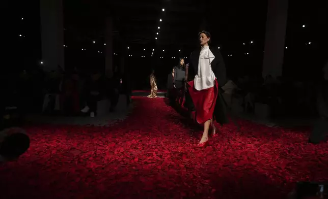 Models wear creations as part of the Ferragamo's Fall/Winter 2025-2026 collection presented in Milan, Italy, Saturday, March 1, 2025. (AP Photo/Antonio Calanni)