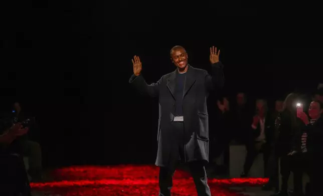 Creative Director Maximillian Davis acknowledges the applause at the end of the Ferragamo's Fall/Winter 2025-2026 collection presented in Milan, Italy, Saturday, March 1, 2025. (AP Photo/Antonio Calanni)