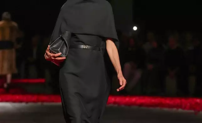 Models wear creations as part of the Ferragamo's Fall/Winter 2025-2026 collection presented in Milan, Italy, Saturday, March 1, 2025. (AP Photo/Antonio Calanni)