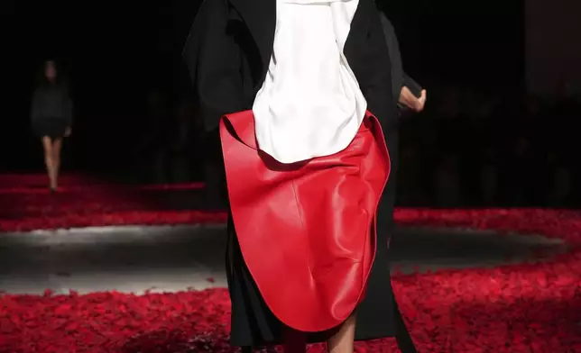 Models wear creations as part of the Ferragamo's Fall/Winter 2025-2026 collection presented in Milan, Italy, Saturday, March 1, 2025. (AP Photo/Antonio Calanni)