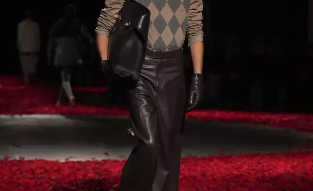 Models wear creations as part of the Ferragamo's Fall/Winter 2025-2026 collection presented in Milan, Italy, Saturday, March 1, 2025. (AP Photo/Antonio Calanni)