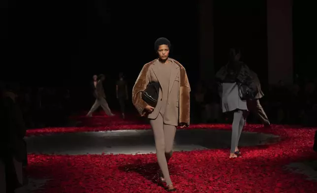 Models wear creations as part of the Ferragamo's Fall/Winter 2025-2026 collection presented in Milan, Italy, Saturday, March 1, 2025. (AP Photo/Antonio Calanni)