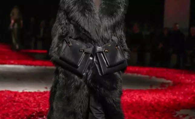 Models wear creations as part of the Ferragamo's Fall/Winter 2025-2026 collection presented in Milan, Italy, Saturday, March 1, 2025. (AP Photo/Antonio Calanni)