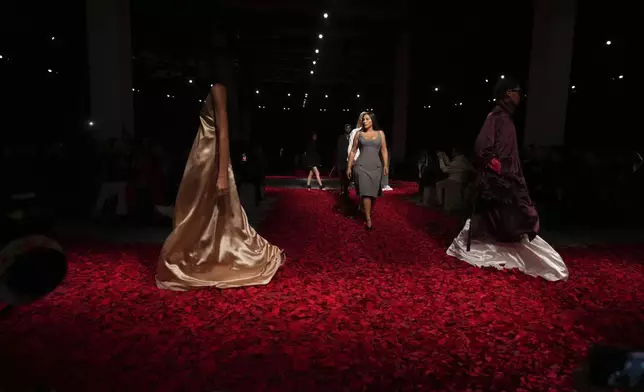 Models wear creations as part of the Ferragamo's Fall/Winter 2025-2026 collection presented in Milan, Italy, Saturday, March 1, 2025. (AP Photo/Antonio Calanni)