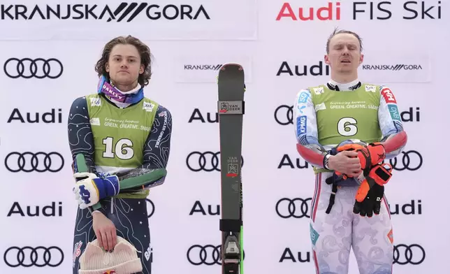 Norway's Henrik Kristoffersen, winner of an alpine ski, men's World Cup giant slalom, listens to the national anthem, next to second-placed Brazil's Lucas Pinheiro Braathen, left, in Kranjska Gora, Slovenia, Saturday, March 1, 2025. (AP Photo/Giovanni Auletta)