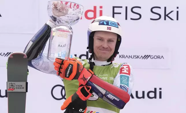 Norway's Henrik Kristoffersen celebrates on the podium after winning an alpine ski, men's World Cup giant slalom, in Kranjska Gora, Slovenia, Saturday, March 1, 2025. (AP Photo/Giovanni Auletta)