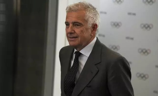 Candidate to the presidency of the International Olympic Committee Juan Antonio Samaranch arrives to the mixed zone during a break of the 144th session, which will elect the new IOC President, in Costa Navarino, western Greece, Wednesday, March 19, 2025. (AP Photo/Thanassis Stavrakis)