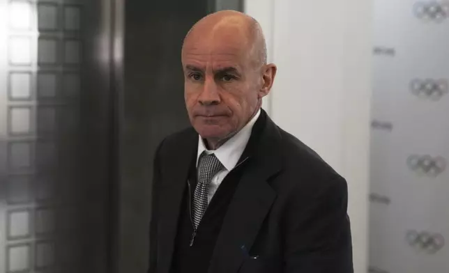 Candidate to the presidency of the International Olympic Committee Johan Eliasch arrives at the mixed zone during a break of the 144th session, which will elect the new IOC President, in Costa Navarino, western Greece, Wednesday, March 19, 2025. (AP Photo/Thanassis Stavrakis)