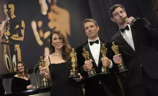Samantha Quan, from left, winner of the award for best picture for "Anora, Sean Baker, winner of the awards for best original screenplay, best film editing, best director, and best picture for "Anora," and Alex Coco, winner of the award for best picture for "Anora," attend the Governors Ball after the Oscars on Sunday, March 2, 2025, in Los Angeles. (AP Photo/John Locher)