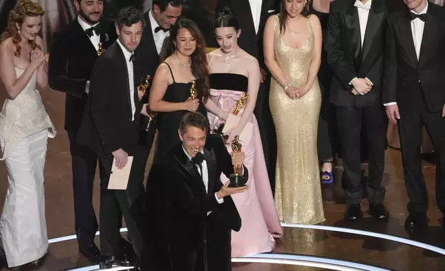 Lindsey Normington, from left, Alex Coco, Vache Tovmasyan, Sean Baker, Samantha Quan, Karren Karagulian Mikey Madison, Drew Daniels, Luna Sofía Miranda, Mark Eydelshteyn, and Yura Borisov accept the award for best picture for "Anora" during the Oscars on Sunday, March 2, 2025, at the Dolby Theatre in Los Angeles. (AP Photo/Chris Pizzello)