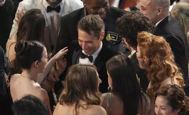 Mikey Madison, left, and Sean Baker appear in the audience during the Oscars on Sunday, March 2, 2025, at the Dolby Theatre in Los Angeles. (AP Photo/Chris Pizzello)
