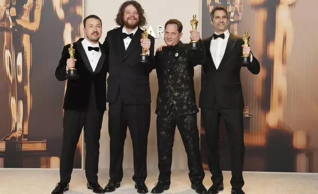 From left, Gints Zilbalodis, Matiss Kaza, Ron Dyens and Gregory Zalcman, winners of the award for best animated feature film for "Flow," pose in the press room at the Oscars on Sunday, March 2, 2025, at the Dolby Theatre in Los Angeles. (Photo by Jordan Strauss/Invision/AP)