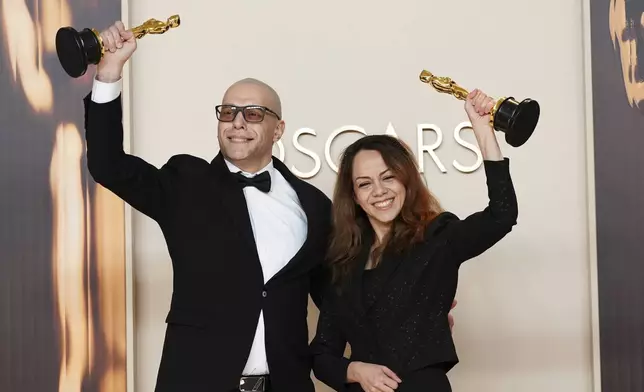 Shirin Sohani, left, and Hossein Molayemi, winners of the award for best animated short for "In the Shadow of the Cypress," pose in the press room at the Oscars on Sunday, March 2, 2025, at the Dolby Theatre in Los Angeles. (Photo by Jordan Strauss/Invision/AP)