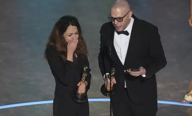 Shirin Sohani, left, and Hossein Molayemi accept the award for best animated short for "In the Shadow of the Cypress" during the Oscars on Sunday, March 2, 2025, at the Dolby Theatre in Los Angeles. (AP Photo/Chris Pizzello)