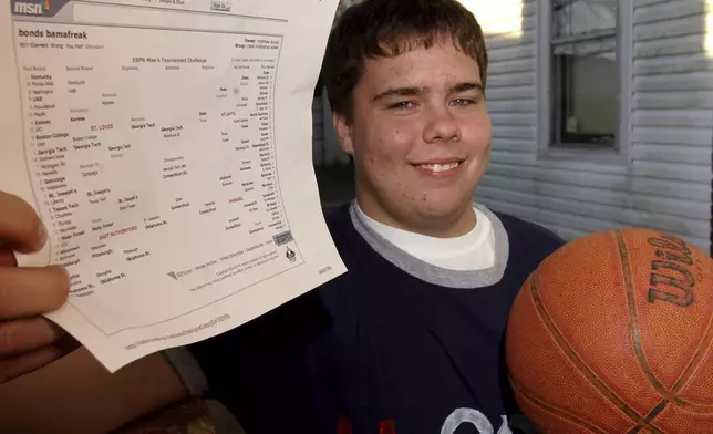FILE - Matthew Bonds of Muscle Shoals, Ala., holds his NCAA men's tournament picks Tuesday, April 6, 2004, in Muscle Shoals, Ala. (Daniel Giles/The TimesDaily via AP, File)
