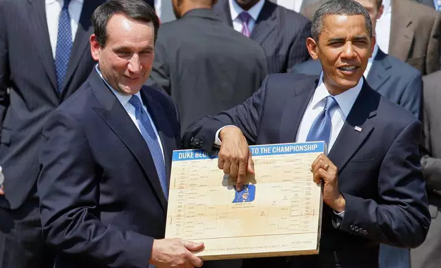 FILE - In this May 27, 2010 file photo, President Barack Obama looks over the bracket with Duke University basketball Coach Mike Krzyzewski in the Rose Garden of the White House in Washington, where he honored the team. (AP Photo/Alex Brandon, File)