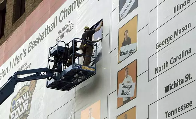 FILE - Construction workers fill out the Final Four NCAA college basketball bracket on the side of the Hyatt Regency building in Indianapolis, Thursday, March 30, 2006. (AP Photo/Ann Heisenfelt, File)