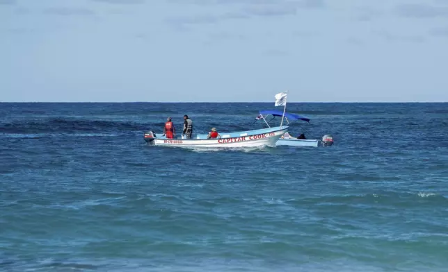 Civil defense boats search for Sudiksha Konanki, a university student from the U.S. who disappeared on a beach in Punta Cana, Dominican Republic, Monday, March. 10, 2025. (AP Photo/Francesco Spotorno)