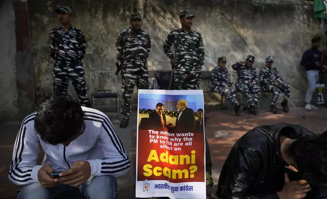 FILE - Members of opposition Congress party, demanding an investigation into allegations of fraud and stock manipulation by India's Adani Group, display a placard with images of Indian businessman Gautam Adani and Indian Prime Minister Narendra Modi during a protest in New Delhi, India, on Feb. 6, 2023. (AP Photo/Manish Swarup, File)