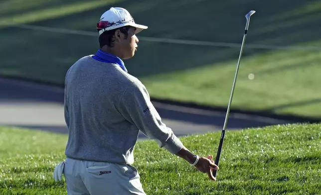Hideki Matsuyama, of Japan, flips his club to his caddie after putting on the 11th hole during a practice round of The Players Championship golf tournament Wednesday, March 12, 2025, in Ponte Vedra Beach, Fla. (AP Photo/Chris O'Meara)