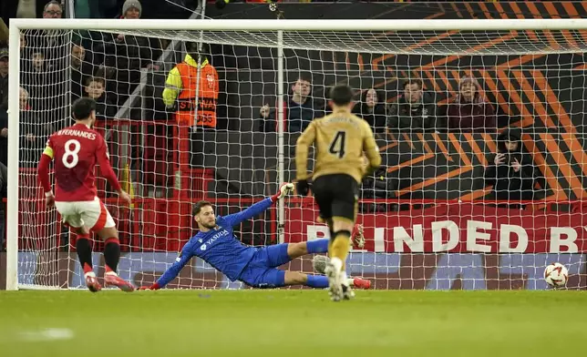 Manchester United's Bruno Fernandes, left, scores his side's second goal by penalty kick during the Europa League soccer match between Manchester United and Real Sociedad at Old Trafford stadium in Manchester, England, Thursday, March 13, 2025 . (AP Photo/Dave Thompson)