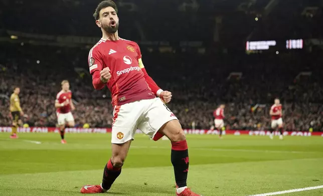 Manchester United's Bruno Fernandes celebrates scoring his side's first goal during the Europa League soccer match between Manchester United and Real Sociedad at Old Trafford stadium in Manchester, England, Thursday, March 13, 2025 . (AP Photo/Dave Thompson)