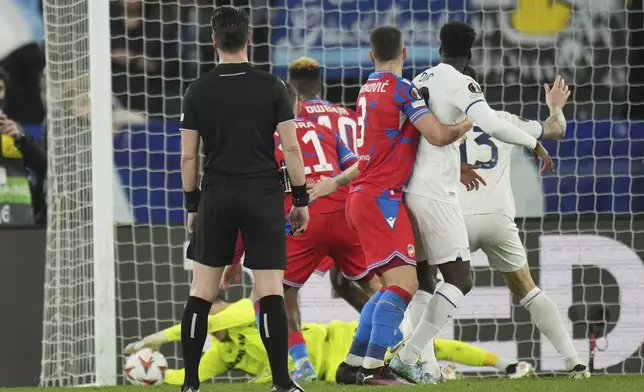 Lazio's Alessio Romagnoli, right, scores his side's first goal during the Europa League round of 16 first leg soccer match between Lazio and Viktoria Plzen, at Rome's Olympic Stadium, Thursday, March 13, 2025. (AP Photo/Andrew Medichini)
