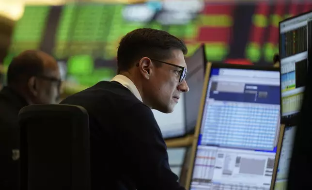 People work on the options floor at the New York Stock Exchange in New York, Wednesday, March 19, 2025. (AP Photo/Seth Wenig)