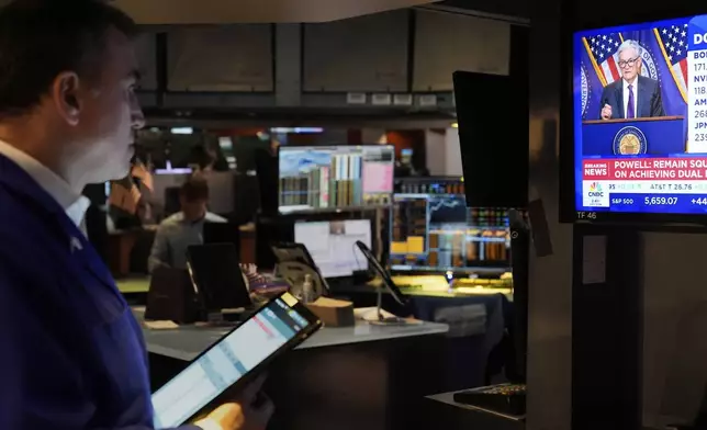 A news conference by Federal Reserve Chair Jerome Powell is displayed on the floor of the New York Stock Exchange in New York, Wednesday, March 19, 2025. (AP Photo/Seth Wenig)