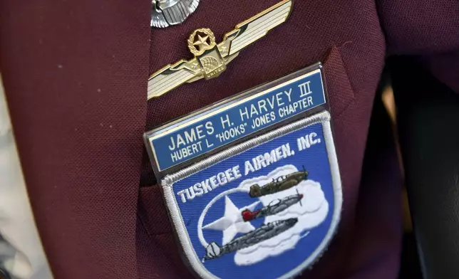 101-year-old Col. James H. Harvey III, one of the last surviving Tuskegee Airmen, wears a jacket adorned with pins and patches at the Veterans Community Living Center in Aurora, Colo., Wednesday, March 12, 2025. (AP Photo/Thomas Peipert)