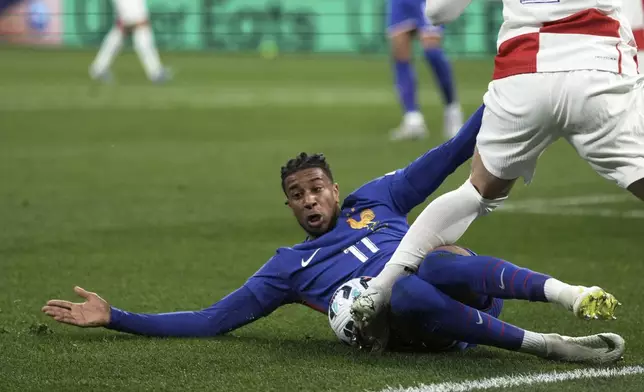 France's Michael Olise challenges Croatia's Duje Caleta-Car during the UEFA Nations League quarterfinal second leg soccer match between France and Croatia, at the Stade de France in Saint-Denis, outside Paris, Sunday, March 23, 2025. (AP Photo/Thibault Camus)