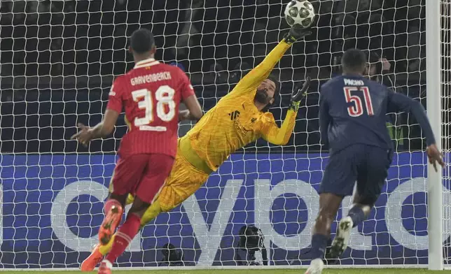Liverpool's goalkeeper Alisson makes a save during the Champions League round of 16 first leg soccer match between Paris Saint-Germain and Liverpool at the Parc des Princes in Paris, Wednesday, March 5, 2025. (AP Photo/Aurelien Morissard)